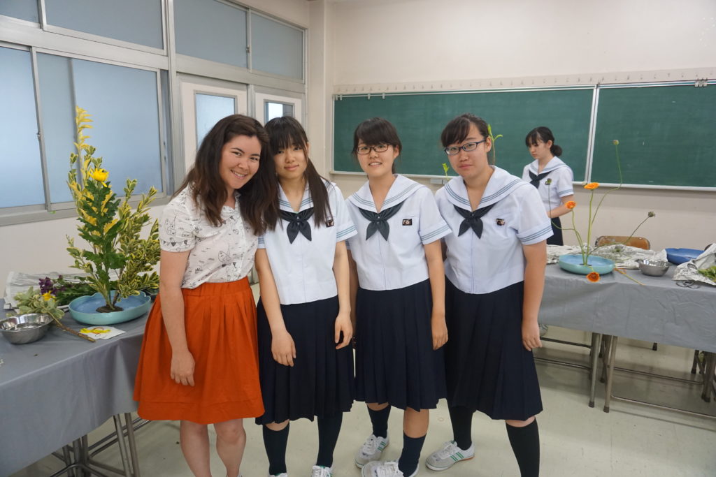 Megan with three students inside a classroom